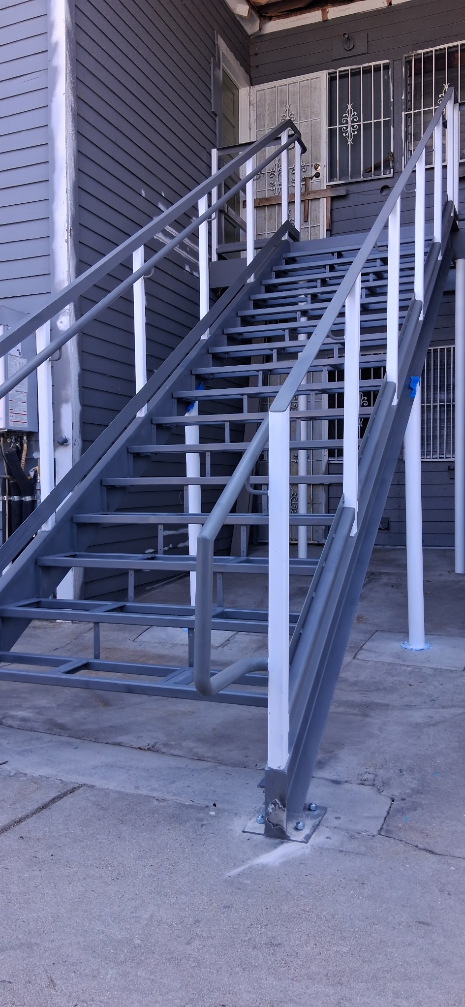 Finished steel exterior staircase with composite treads and railings